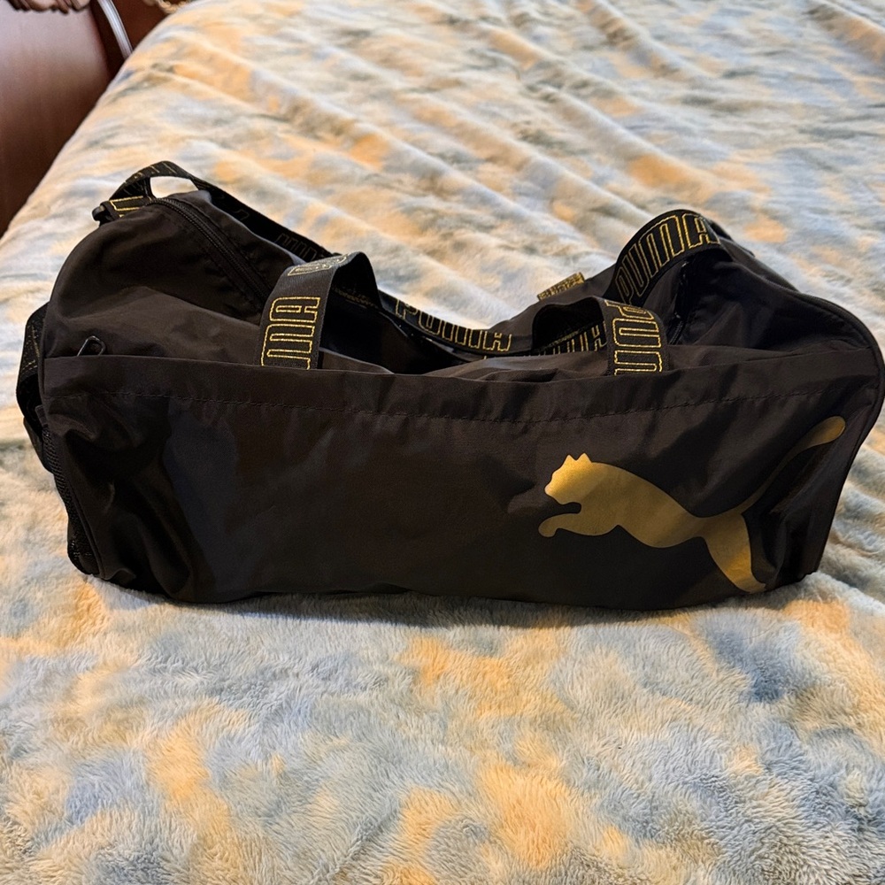 Puma Black Duffel Bag with Gold Puma Logo and Branded Straps